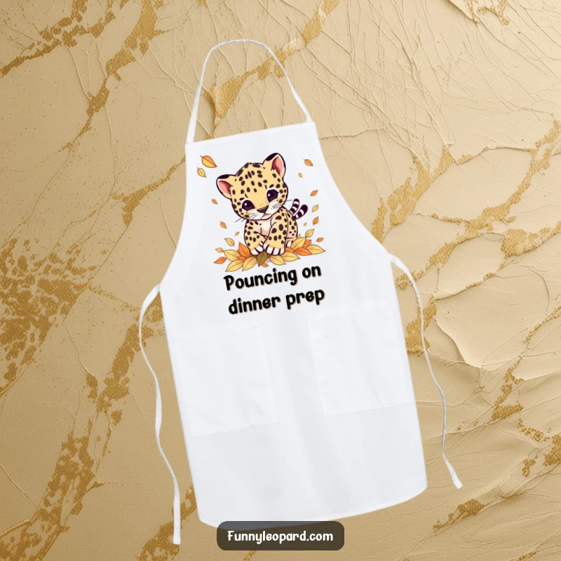 Funny apron with a cute leopard cub playfully pouncing on falling autumn leaves, designed for kitchen fun and protection.
