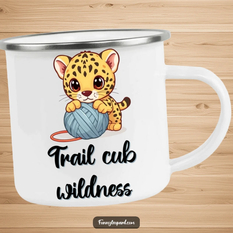 Funny leopard cub camping mug, a cute kitten playfully pouncing on a yarn ball with big eyes, perfect for outdoor fun.
