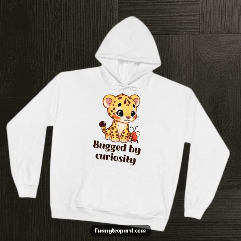 Funny hoodie showing a curious leopard cub cub tilting its head, examining a wiggling bug with adorable wonder.