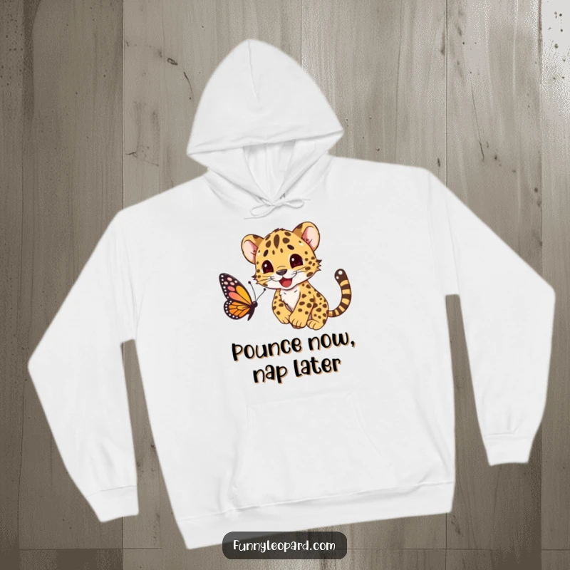 Funny hoodie showing a happy leopard cub cub energetically pouncing on a butterfly, capturing a moment of pure fun.