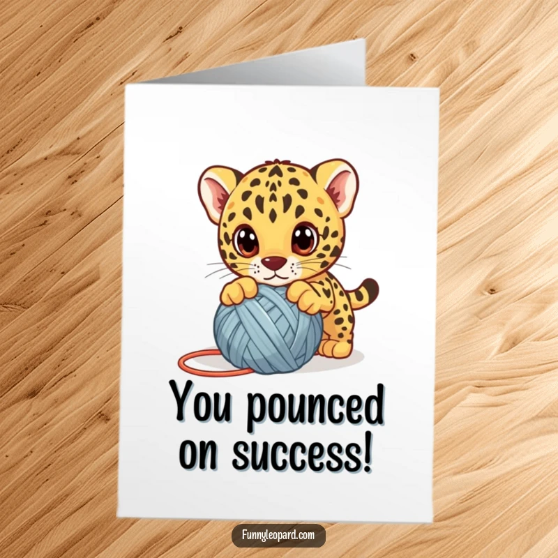 Funny Free Printable Congratulations Card: A cute leopard cub playfully attacks a yarn ball, celebrating success with big eyes.