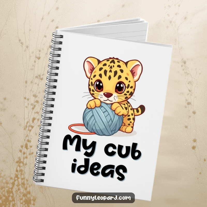 Funny leopard cub notebook, a cute kitten playfully pouncing on a yarn ball with big eyes, perfect for notes with humor.